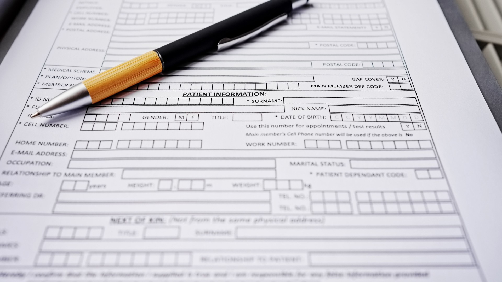 Patient information form with pen lying on top in a medical clinic